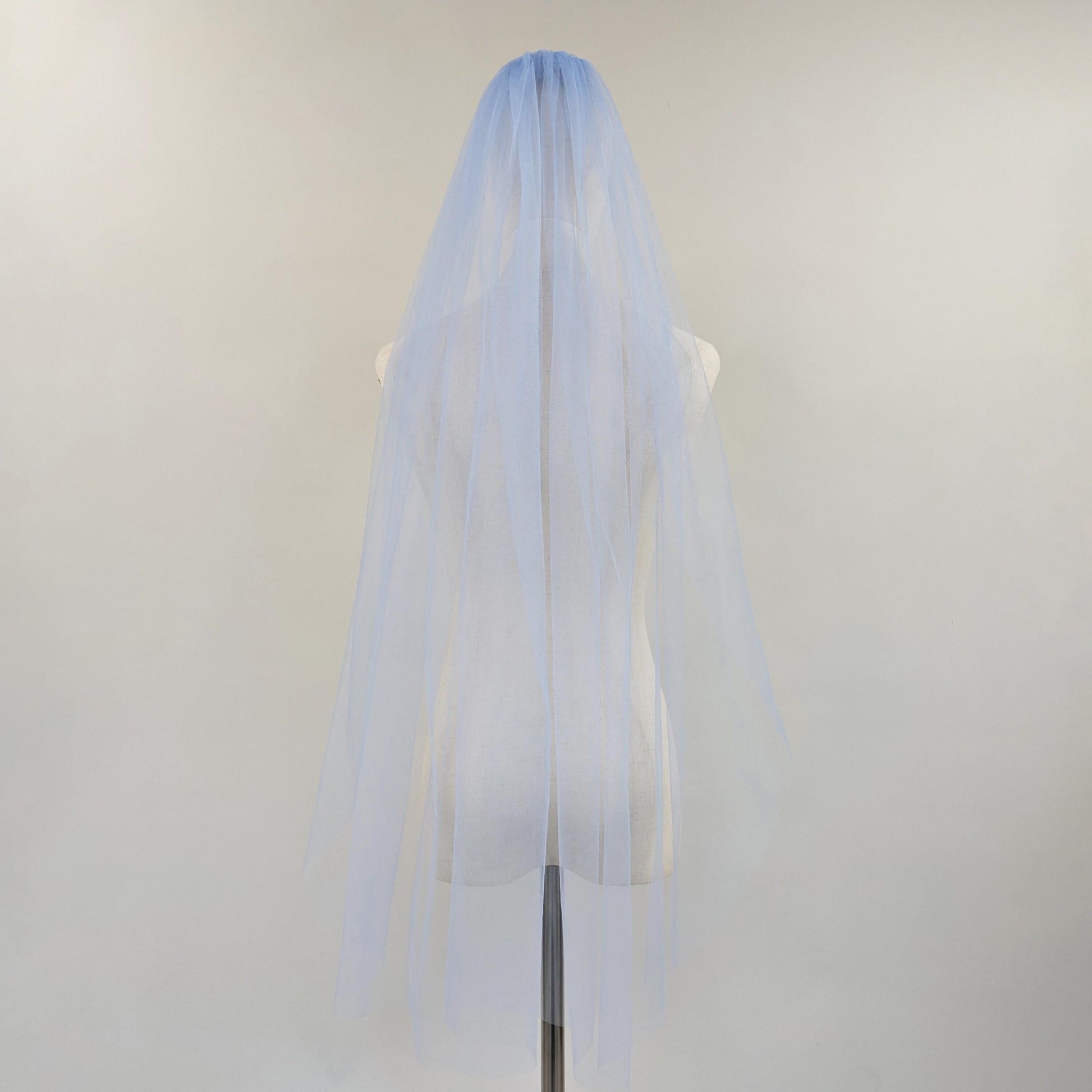 Light blue wedding veil on a mannequin head against a white background